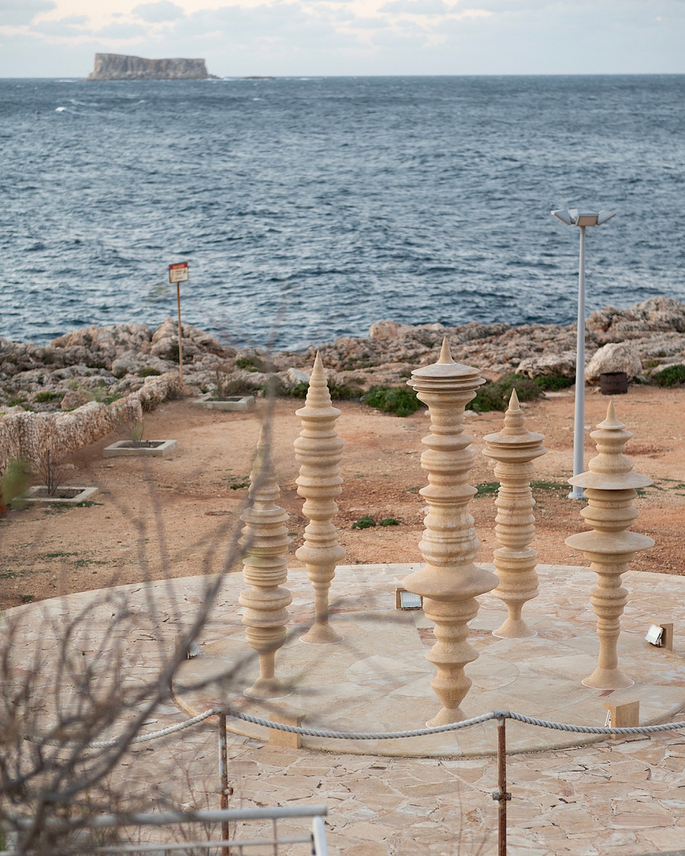 Carved stone pillars in Adrian MM Abela’s Court for Concealed Thoughts, overlooking the sea in Malta